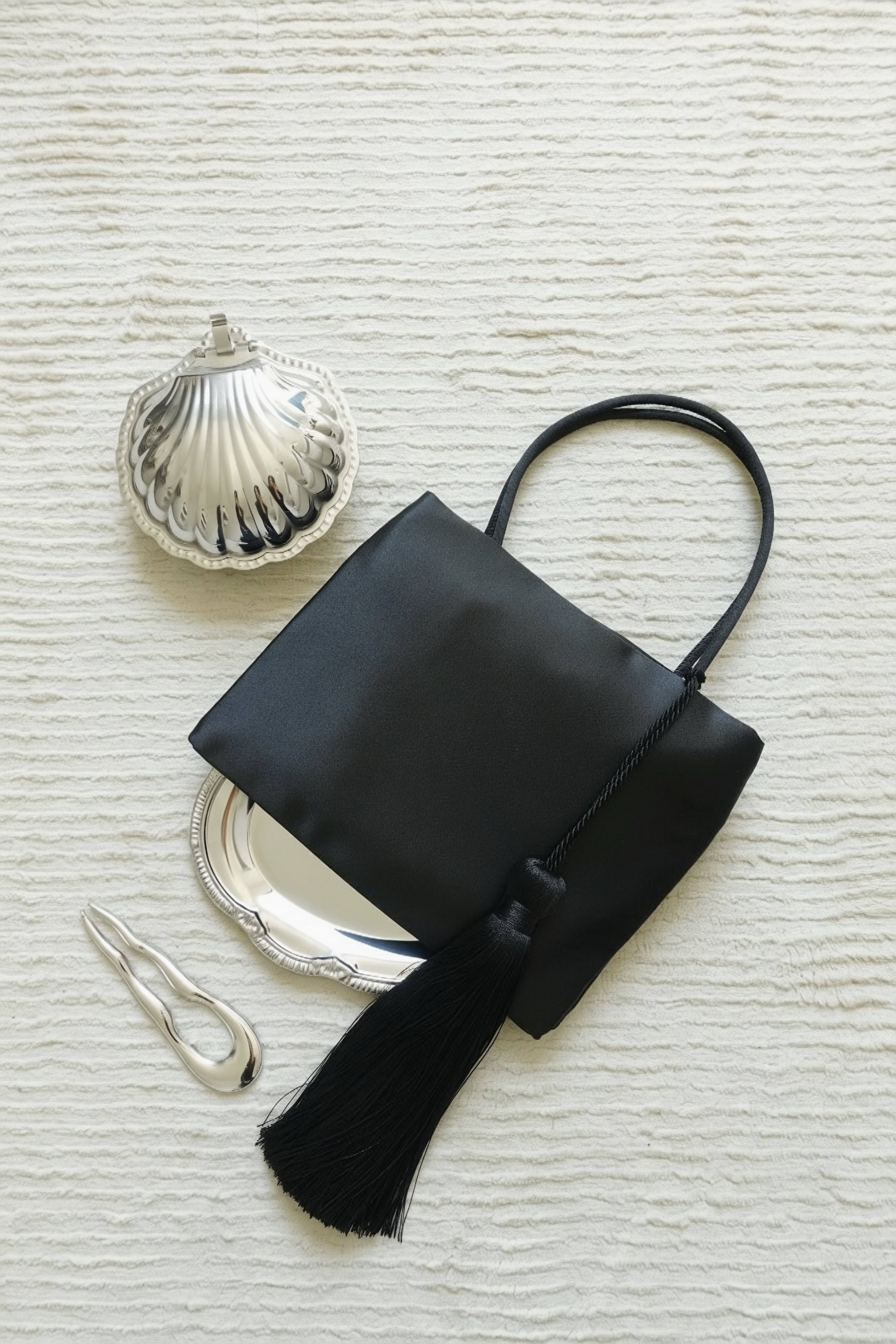 Minimalist Black Nylon Top Handle Bag with Statement Silk Tassel Accent