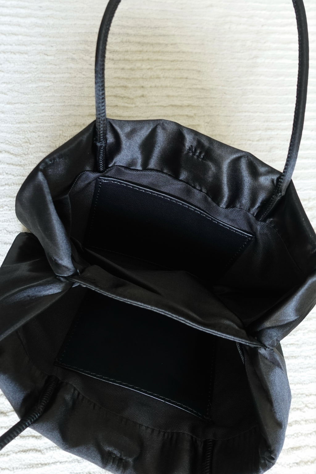 Minimalist Black Nylon Top Handle Bag with Statement Silk Tassel Accent