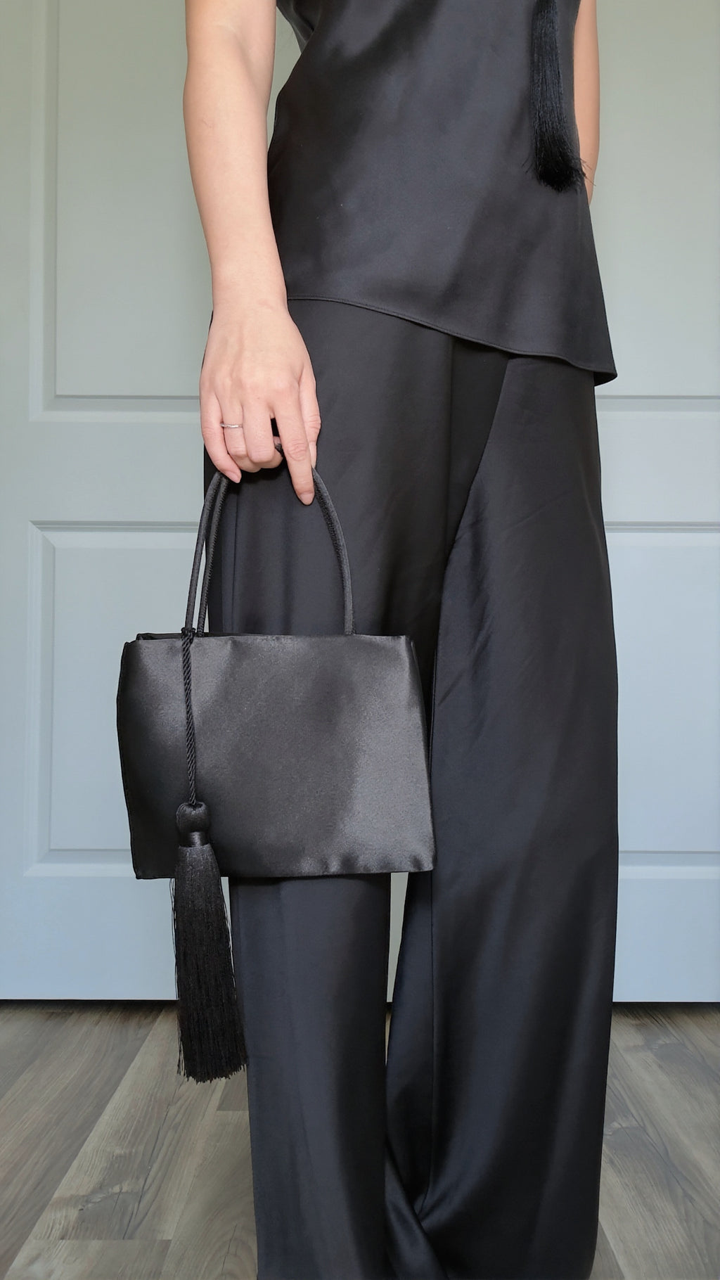 Minimalist Black Nylon Top Handle Bag with Statement Silk Tassel Accent
