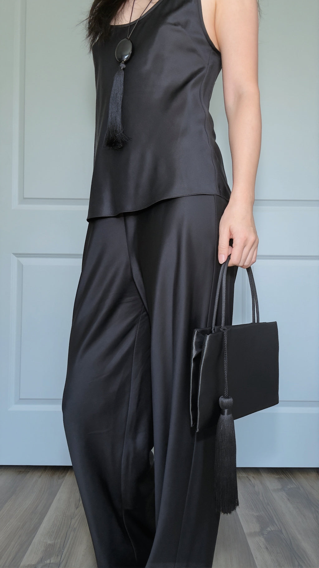 Minimalist Black Nylon Top Handle Bag with Statement Silk Tassel Accent